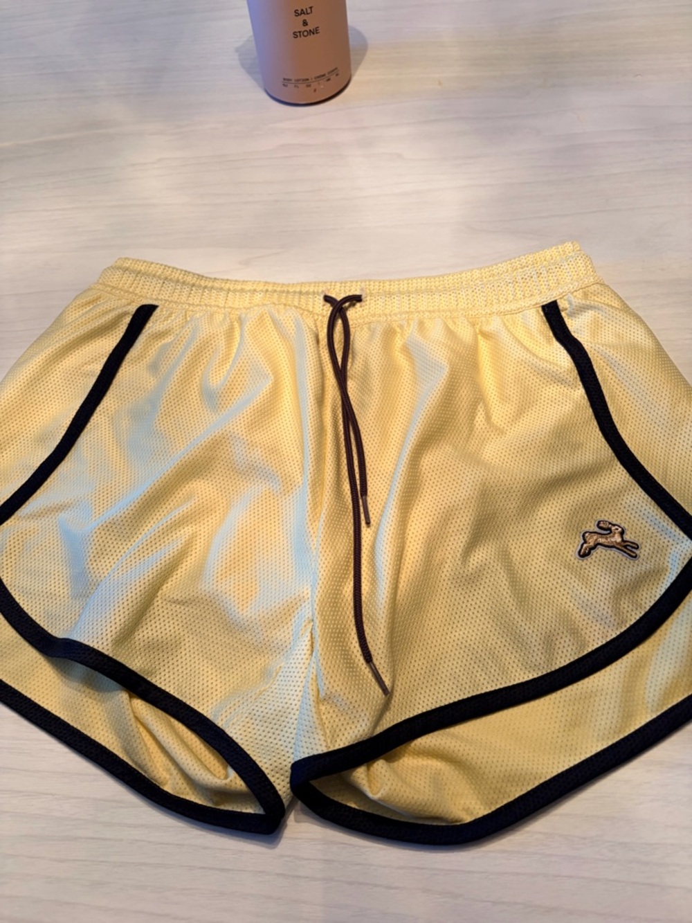 Tracksmith Van Cortlandt Yellow Athletic Shorts with Black Trim